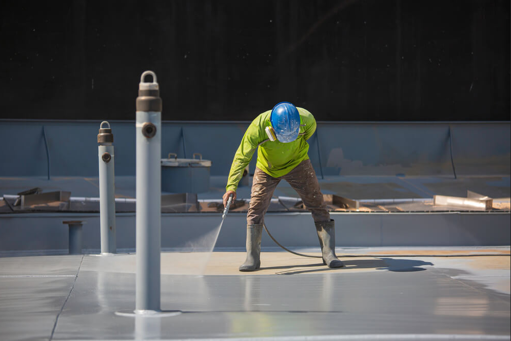 Maintenance work on a low-slope commercial roof membrane