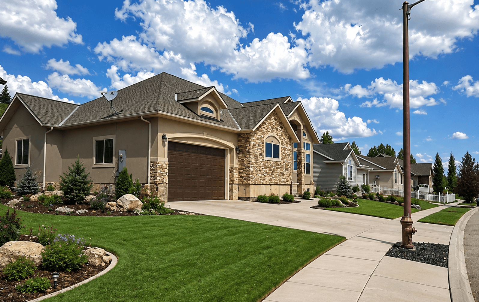 Finished home with a stone exterior and dark asphalt shingle roof