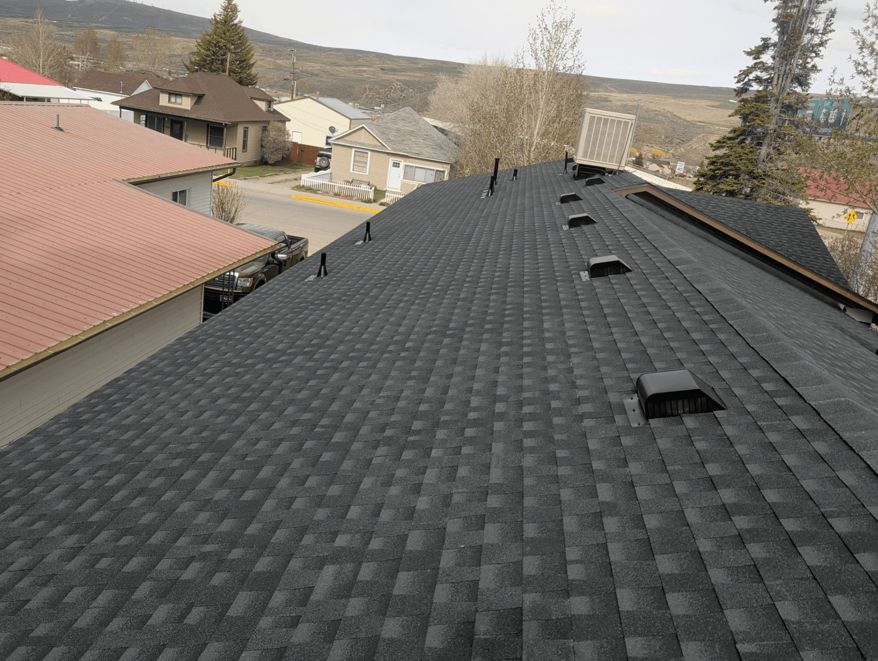 Completed asphalt shingle roofing system with vents and penetrations